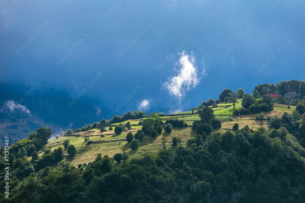 Carpathian mountains landscape in Romania. Village on the hill a