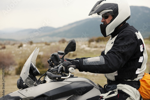 Man Driving a Motorcycle in Nature