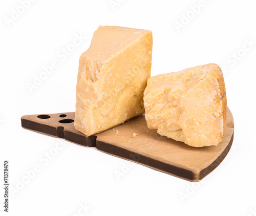 Parmesan cheese two stacks on wooden plate isolated on white