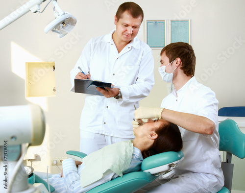 Young woman with dentist in a dental surgery. Healthcare 