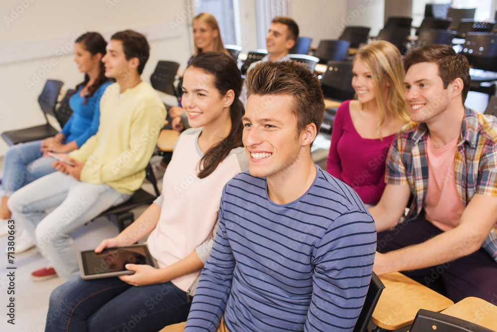 group of smiling students with tablet pc