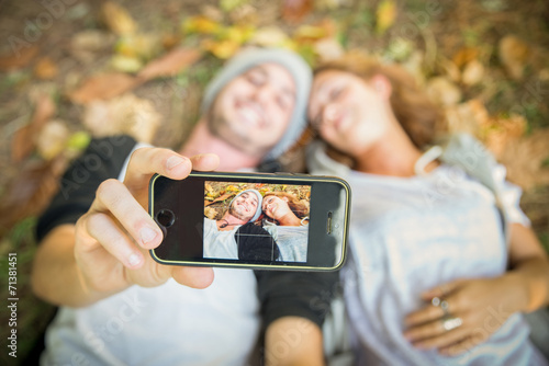 Couple taking selfie in autumn photo