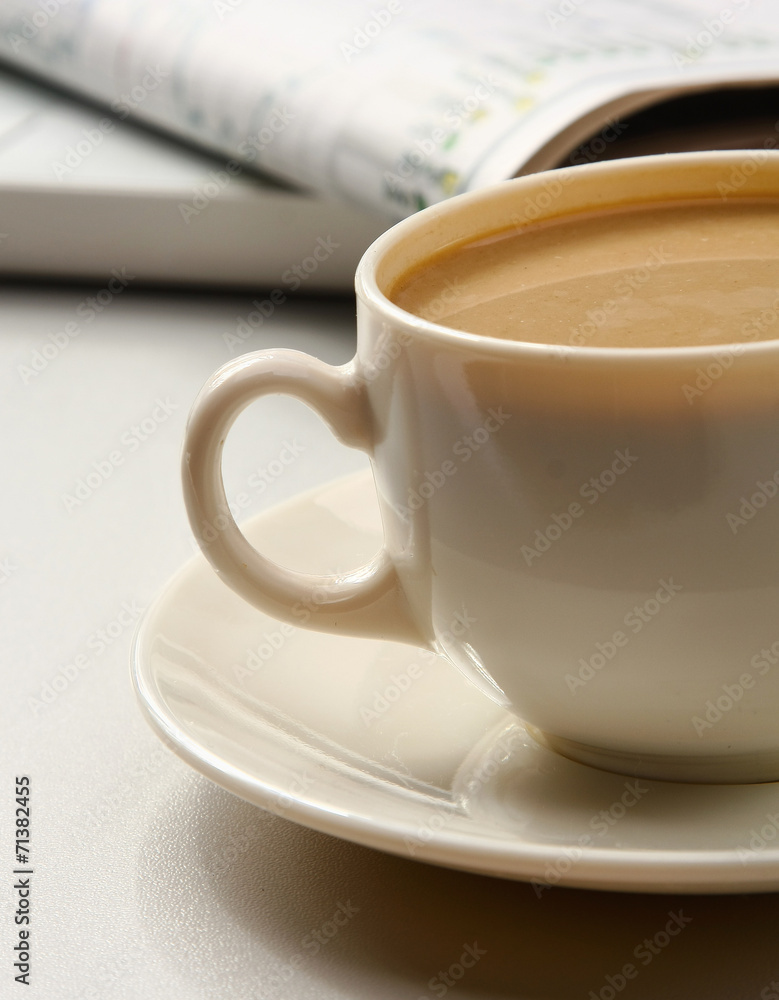 Fototapeta premium cup near newspapers