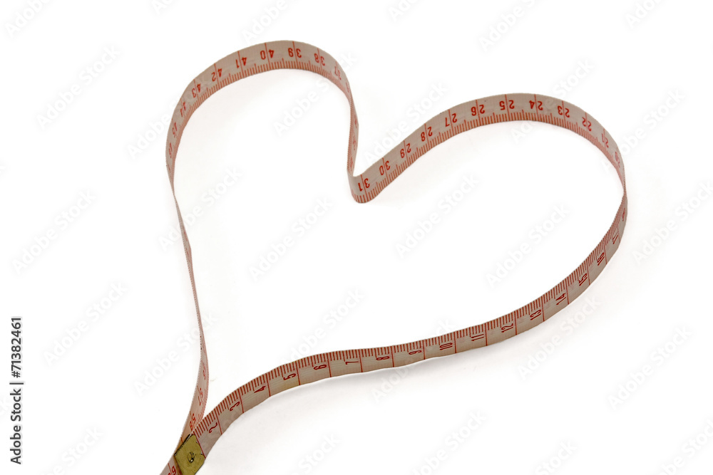 A measuring tape shaping a heart. A measuring tape shaping a heart.