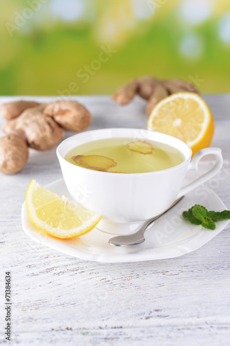 Ginger tea with lemon on table on light background