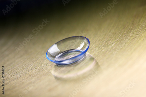 Contact lens on color background