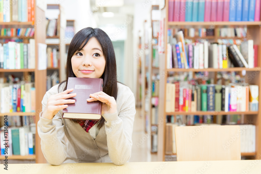 young asian student studying in the library young asian student studying in the library