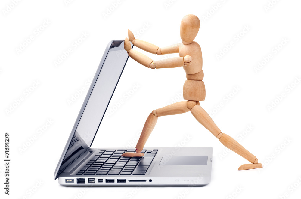 Wooden man opens a laptop Wooden man opens a laptop