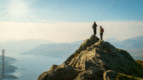 Obraz na płótnie hikers on top of the mountain enjoying view, Highlands, Scotland