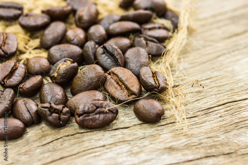Coffee beans on sacking and wood background