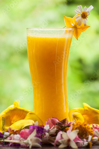 Mango juice in glass with star fruit slice