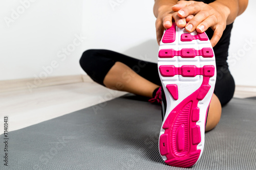 Woman stretching in a gym