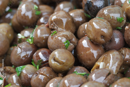 Fresh olives marinated with herbs macro. background