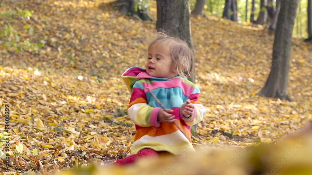 Baby playing with yellow leaves. Baby playing with yellow leaves.
