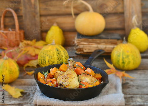 the baked chicken with pumpkin in a pig-iron frying pan photo