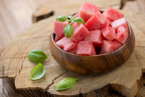 Wooden bowl with watermelon cubes, close-up, horizontal shot