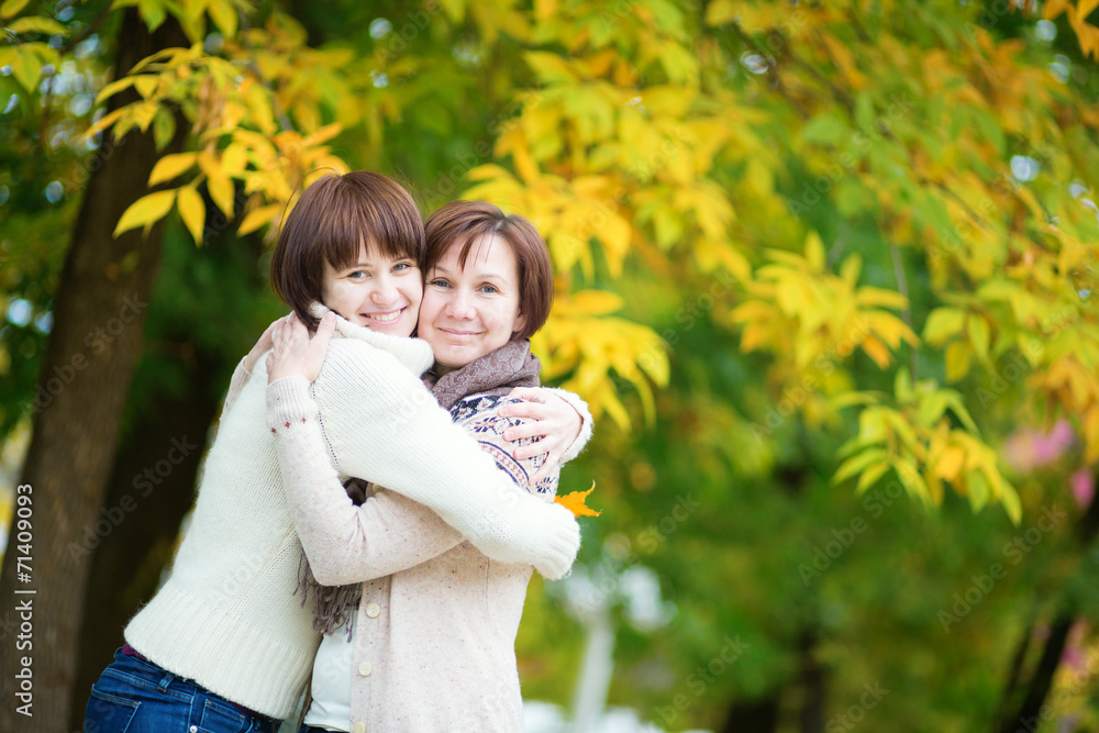 Middle aged woman with daughter on a fall day Middle aged woman with daughter on a fall day