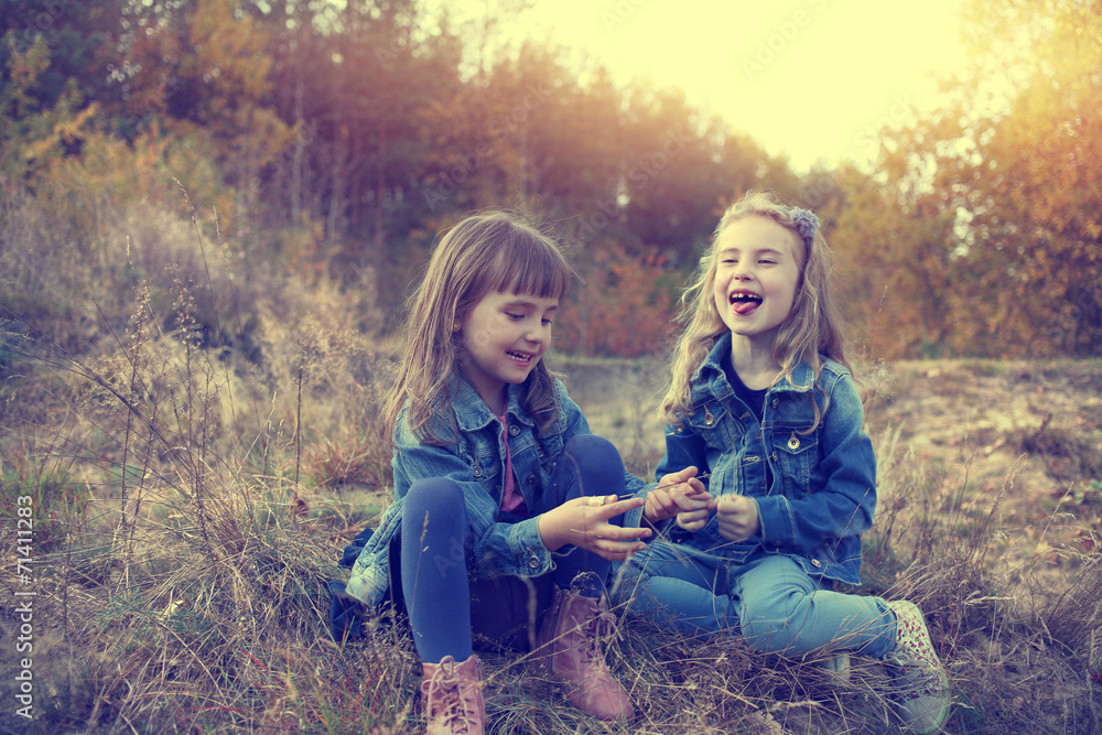 Two young girls amused at autumn sunny day Two young girls amused at autumn sunny day
