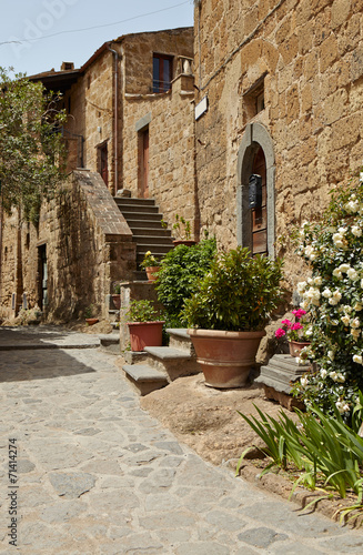 Old small stone medieval street in historical town, Italy