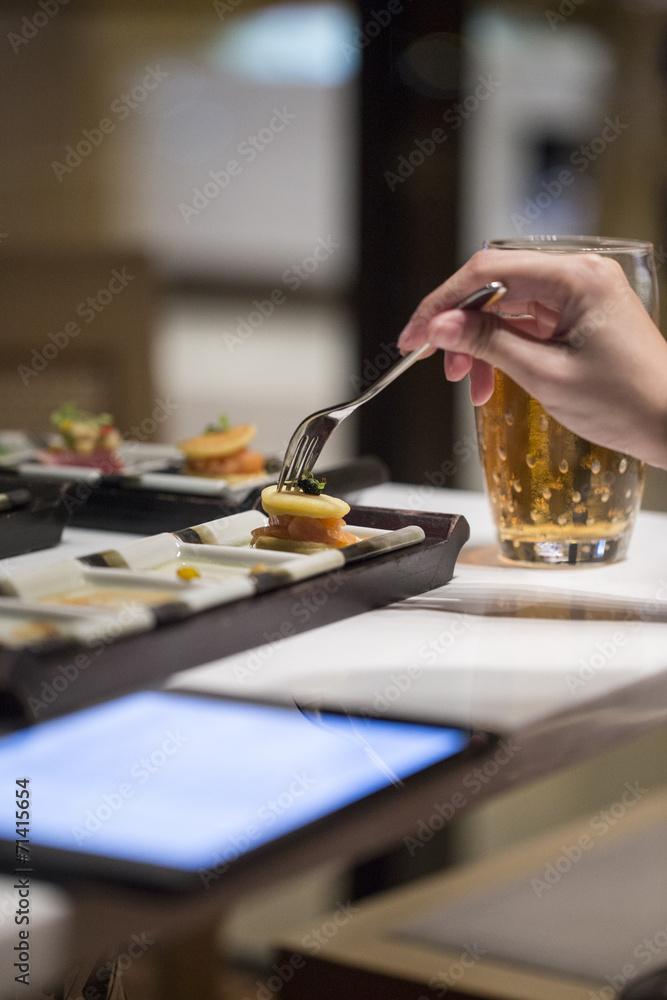 Working woman eating cocktail food with fork Working woman eating cocktail food with fork