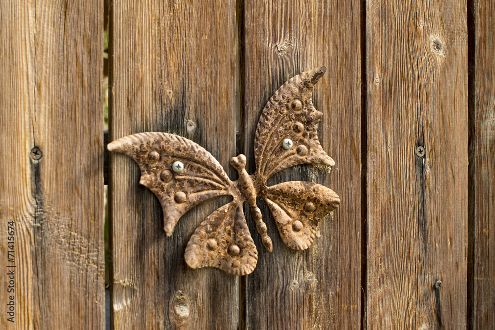 Authentic rusty butterfly on a wooden fence Authentic rusty butterfly on a wooden fence