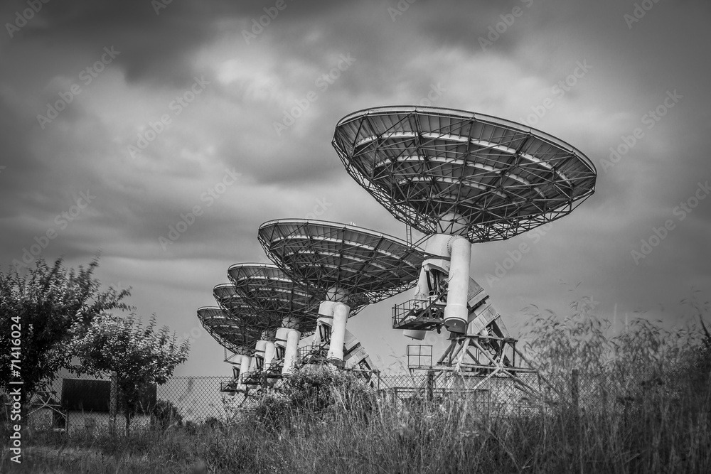 Stormy sky, radio dish array in black and white