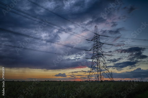 Electricity pylon at dusk and storm on the horizon