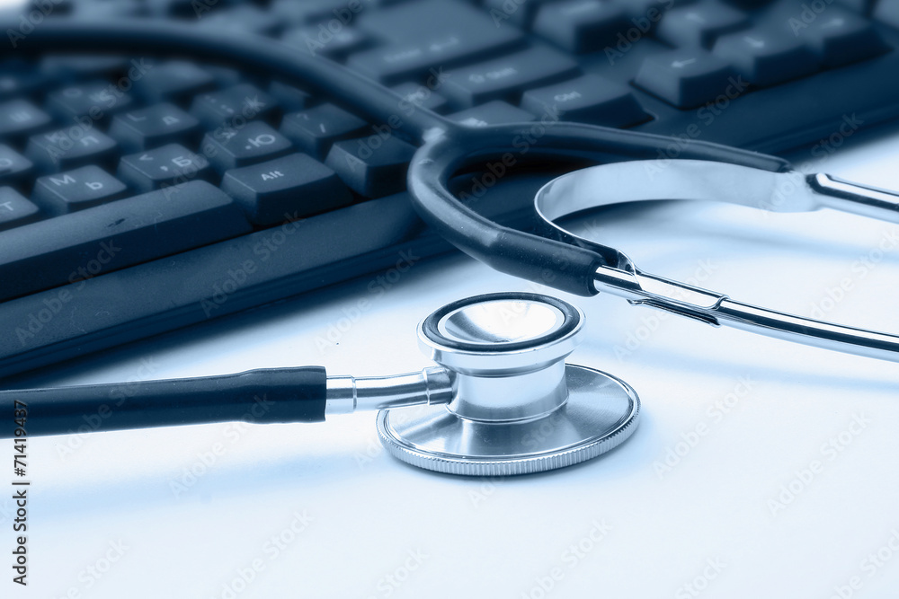 Stethoscope on silver laptop computer Stethoscope on silver laptop computer