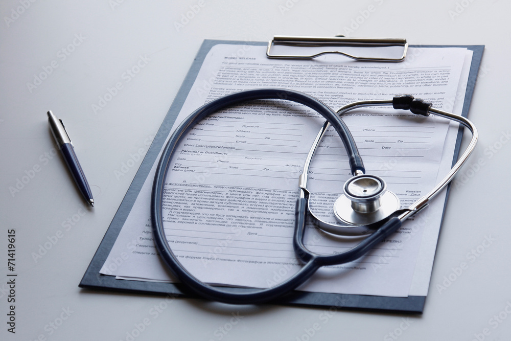 Medical clipboard and stethoscope isolated on white Medical clipboard and stethoscope isolated on white