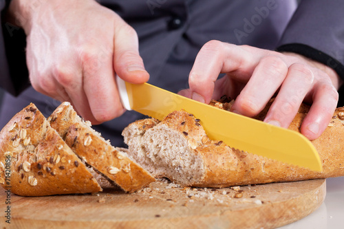 Close-up of a chef cuts bread cereal