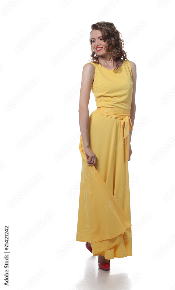 Smiling curly girl posing in stylish yellow dress Smiling curly girl posing in stylish yellow dress