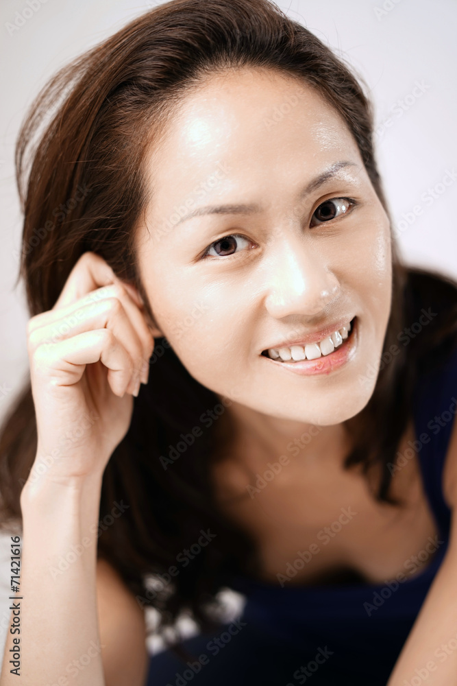 Asian chinese lady striking a glamour pose and smiling Asian chinese lady striking a glamour pose and smiling