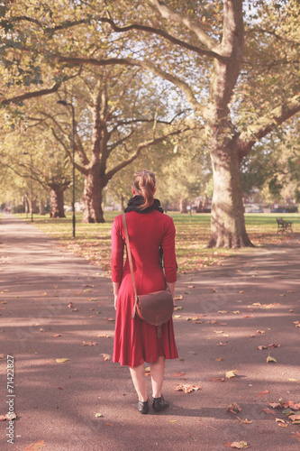 Young woman walking in the park © LoloStock