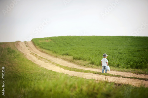 Little boy walking in nature