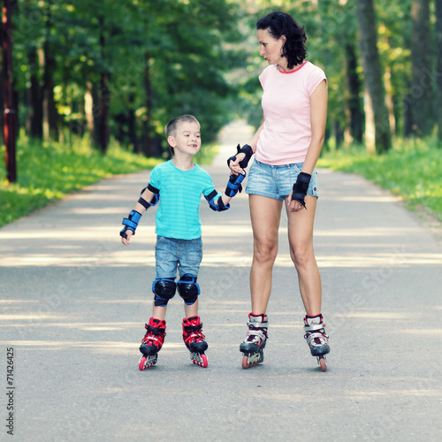 mother and son learn to roller skate. 
