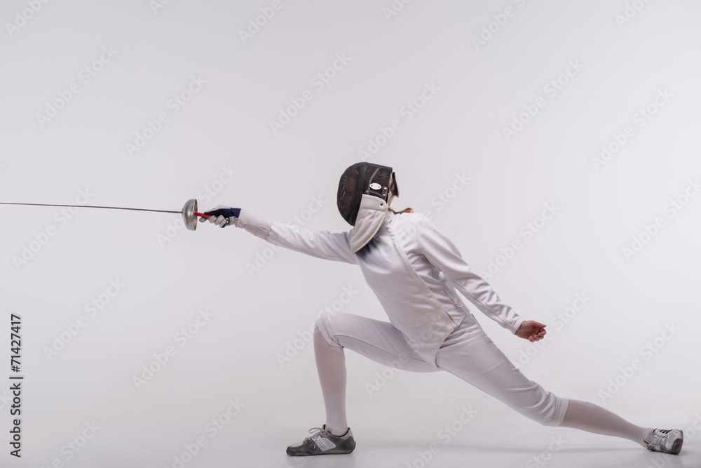 Young woman engaging in fencing Young woman engaging in fencing