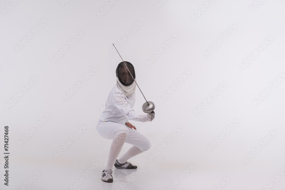 Young woman engaging in fencing Young woman engaging in fencing