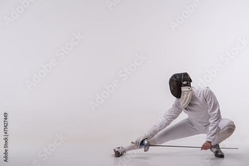 Slika na platnu Young woman engaging in fencing