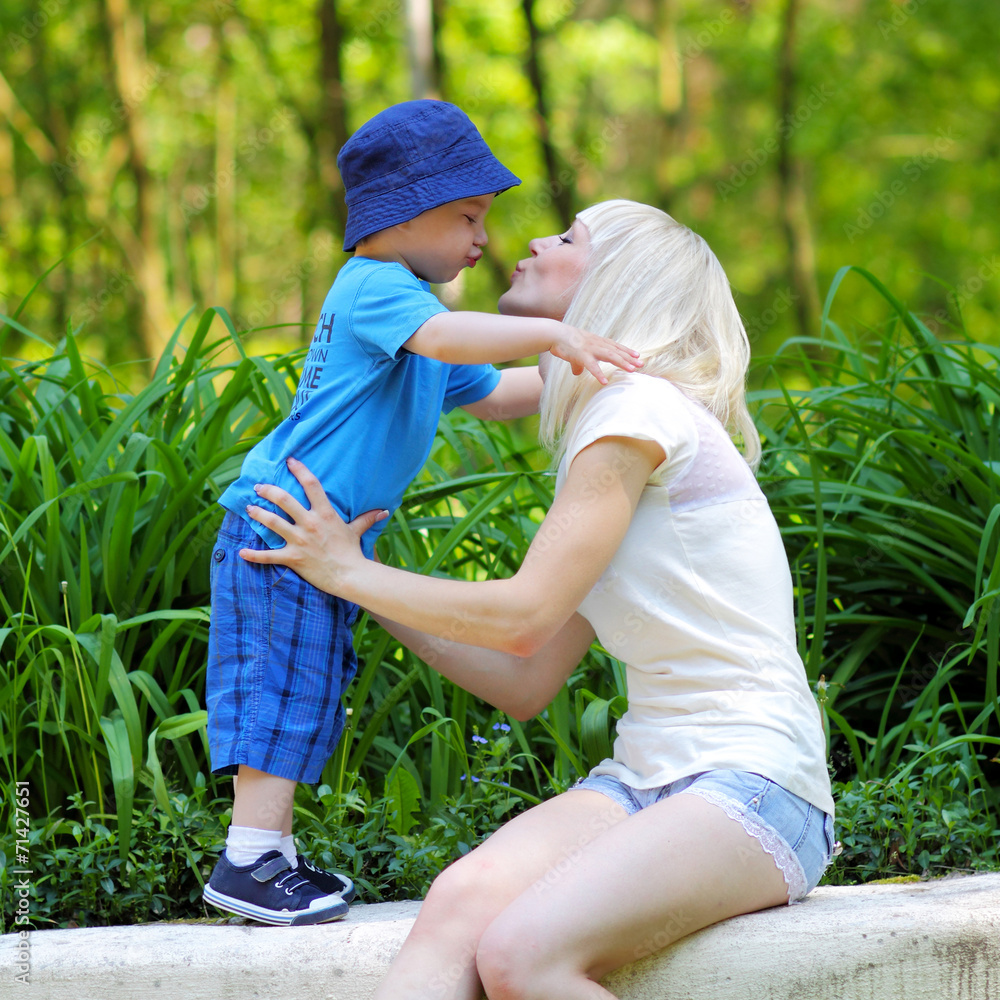 little boy hugging his mother. Happy family. little boy hugging his mother. Happy family.