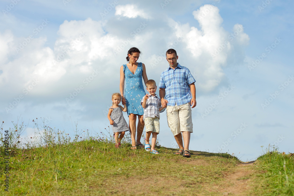 young happy family of four down from the mountains young happy family of four down from the mountains