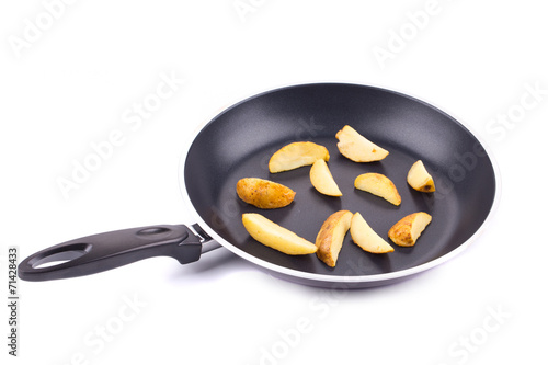 Frying pan with potatoes closeup
