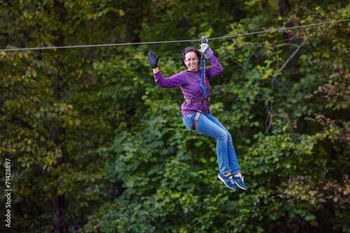 Young woman having fun on long rope route
