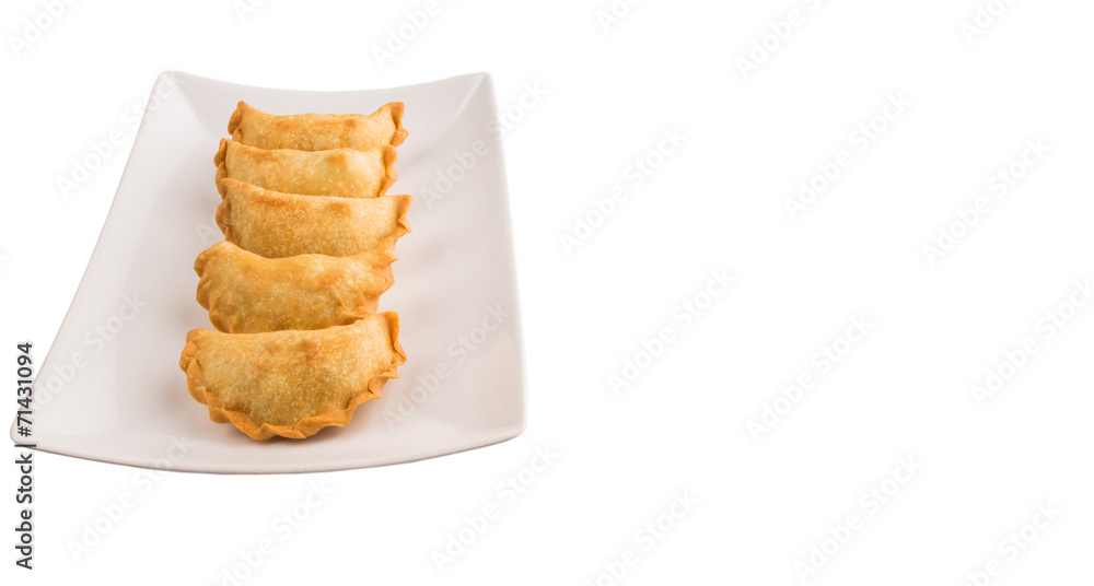 Popular traditional Malaysian snack curry puff on a white plate Popular traditional Malaysian snack curry puff on a white plate