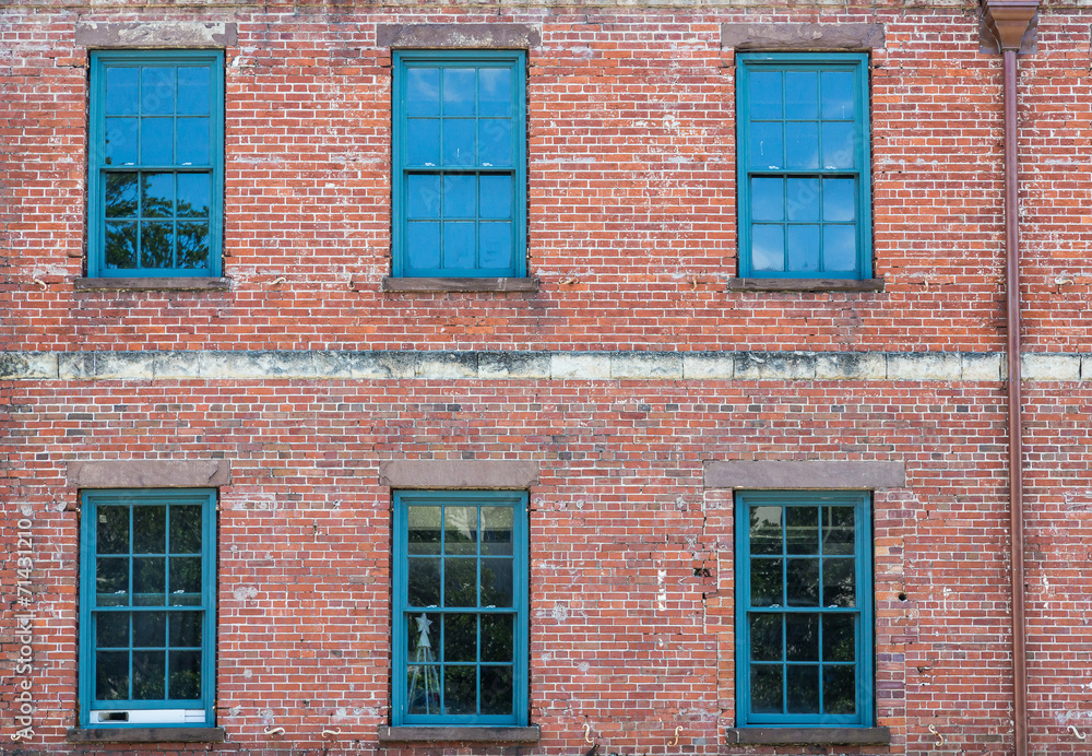 Six Green Windows on Old Brick Building