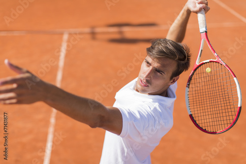 Young man playing tennis © BGStock72