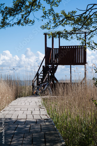 Two bikes parked at the tower in front of Kursian bay