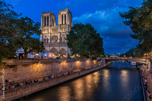 The Cathedral of Notre Dame de Paris and Seine River in the Even