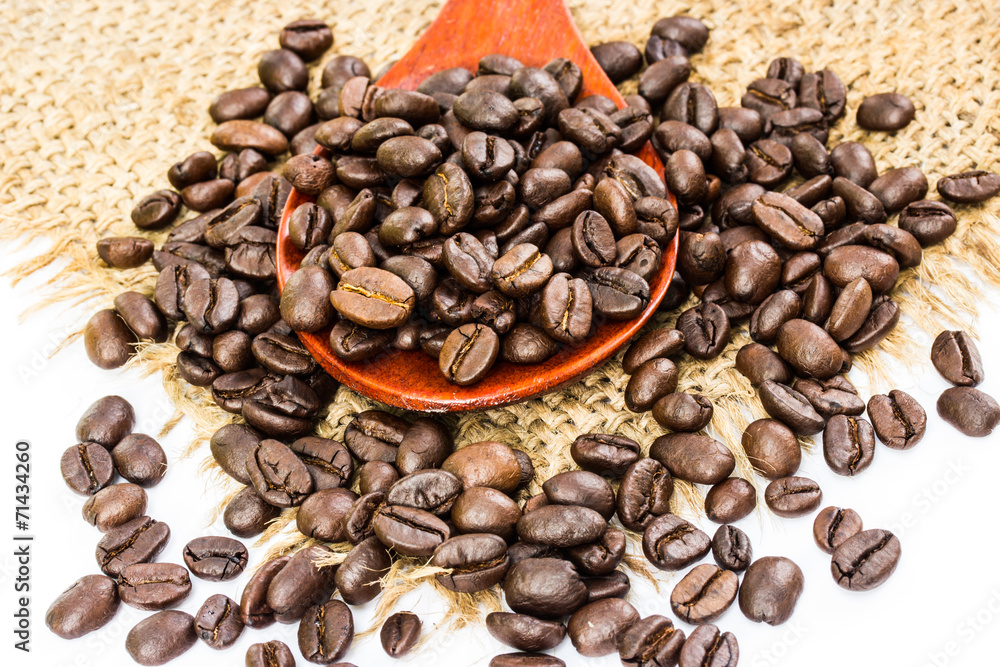 coffee beans on sacking and wood spoon, white background coffee beans on sacking and wood spoon, white background