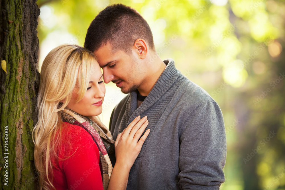Young couple enjoying worm autumn day in nature Young couple enjoying worm autumn day in nature