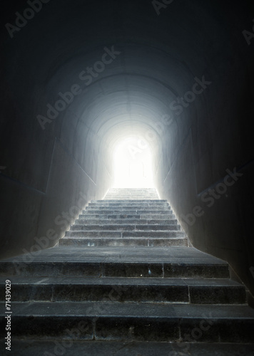 staircase in the tunnel with light at the end